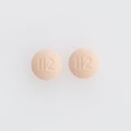 Closeup shot of two round medical pills isolated on a white background Royalty Free Stock Photo