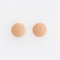 Closeup shot of two round medical pills isolated on a white background Royalty Free Stock Photo