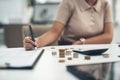 Working on her company& x27;s balance sheet. Closeup shot of an unrecognisable businesswoman calculating finances in an Royalty Free Stock Photo