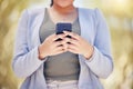 Finally a chance to respond to some texts. Closeup shot of an unrecognisable businesswoman using a cellphone outdoors. Royalty Free Stock Photo