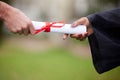 Unlock your potential even further with this token. Closeup shot of an unrecognisable graduate receiving their Royalty Free Stock Photo