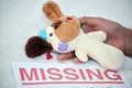 One missing child is one too many. Closeup shot of an unrecognisable woman holding a teddy bear alongside a missing
