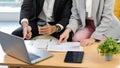 Closeup shot of unrecognizable unknown businesswoman in formal suit hand and finger touching typing working with laptop notebook Royalty Free Stock Photo