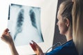Closeup shot of an unrecognizable young caucasian female doctor holding lung x-ray, examining her patient& x27;s Royalty Free Stock Photo