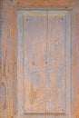 Closeup shot of an upper part of an old wooden door with worn off paint. Royalty Free Stock Photo