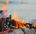 Closeup shot of urning and glowing charcoal with open hot flame and smoke Royalty Free Stock Photo