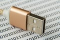 Closeup shot of a USB cable on a piece of paper with numbers and codes written on it