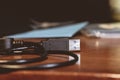 Closeup shot of a USB cable on a wooden table Royalty Free Stock Photo