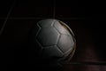 Closeup shot of a used soccer ball on a dark floor Royalty Free Stock Photo