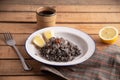 Closeup shot of Valencian black paella with black rice, squid and prawns