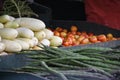 Closeup shot of variety of ripe vegetables on a stall for sale with blur background