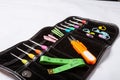 Closeup shot of various knitting tools, needles, scissors, spools, measuring tape in a bag Royalty Free Stock Photo