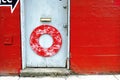 Closeup shot of a vibrant red wall with a white door perfect for a messy abstract background