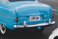 Closeup shot of a vintage blue car with a LMFAO license plate