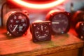 Closeup shot of vintage gauges with red neon lights behind them