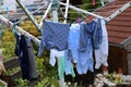 Closeup shot of washed newborn clothes hanging on ropes Royalty Free Stock Photo