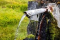 Closeup shot of water flowing from an old rusty pipe Royalty Free Stock Photo