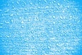 Closeup shot of waterdrops on a blue surface- background Royalty Free Stock Photo