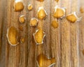 Closeup shot of waterdrops on a wooden surface