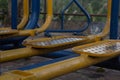 Closeup shot of weathered metal yellow steps on playground equipment