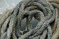 Closeup shot of a weaved weathered rope on the ground