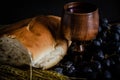 Closeup shot of wheat, white bread, grapes, and red wine in a wooden glass Royalty Free Stock Photo