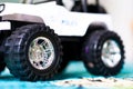 Closeup shot of the wheels of a toy car on the carpet Royalty Free Stock Photo