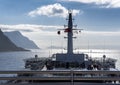 Closeup shot of a white battlecruiser on the shore on a sunny day in Alesund, Norway