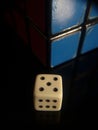 Closeup shot of white dice and Rubik's cube isolated on a black background Royalty Free Stock Photo