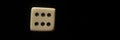 Closeup shot of white dice showing six pips isolated on a black background Royalty Free Stock Photo