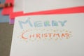 Closeup shot of a white festive Merry Christmas note