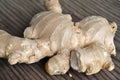 Closeup shot of white ginger roots on a brown surface Royalty Free Stock Photo