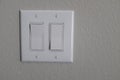 Closeup shot of a white on/off switch on the wall Royalty Free Stock Photo