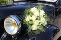 Closeup shot white roses bouquet on the vintage wedding car Royalty Free Stock Photo
