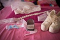 Closeup shot of white shoes,headband with a blue bow and a gold ring with crystal in a jewelry box