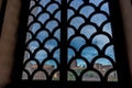 Closeup shot of a window with a metal fence and a cityscape in the background in Rome, Italy Royalty Free Stock Photo