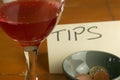 Closeup shot of wine glass with a bowl of tips background