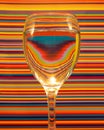 Closeup shot of a wine glass with water on a colorful background Royalty Free Stock Photo