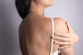 Woman from back having neck or shoulder pain. Injury or muscle spasm. Back and spine disease. Female massaging her neck. Royalty Free Stock Photo