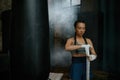 Closeup shot of woman boxer wrapping her hands in bandage Royalty Free Stock Photo