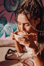 Closeup shot of woman in cafe drinking capuccino