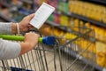 Shopping with a plan. Closeup shot of a woman checking her shopping list in a grocery store. Royalty Free Stock Photo