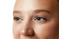 Closeup shot of woman eyes with day makeup against white studio background. Preorbital zone and mimicable wrinkles