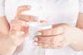 Closeup shot of woman hands applying moisturizing hand cream Royalty Free Stock Photo