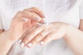 Closeup shot of woman hands applying moisturizing hand cream Royalty Free Stock Photo