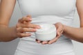 Closeup shot of woman hands holding cream and applying moisturizing hand cream. Beautiful female hands with cream. Royalty Free Stock Photo