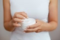 Closeup shot of woman hands holding cream and applying moisturizing hand cream. Beautiful female hands with cream. Hand Skin Care. Royalty Free Stock Photo