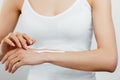 Closeup shot of woman hands holding cream and applying moisturizing hand cream. Beautiful female hands with cream. Royalty Free Stock Photo