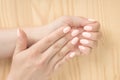 Closeup shot of a woman in a nail salon getting a manicur. women`s hands with an excellent manicure on the background of a wooden