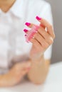 Closeup shot of woman in nail salon receiving manicure by beautician with nail file and machine. Woman getting nail Royalty Free Stock Photo